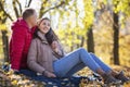 Young laughing man and woman hugging in the autumn park. Romantic couple on a date. Love and tenderness in a relationship. Close- Royalty Free Stock Photo