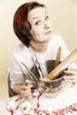 Young laughing woman bakes Christmas cookies for the holiday.