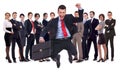 Young leader jumping for joy in front of his team Royalty Free Stock Photo