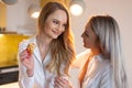 Young lesbian couple in kitchen smiling to each other Royalty Free Stock Photo
