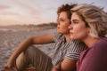 Young lesbian couple sitting on a beach watching the sunset Royalty Free Stock Photo