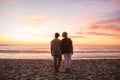 Young lesbian couple standing on a beach watching the sunset Royalty Free Stock Photo