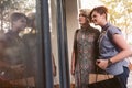 Smiling lesbian couple window shopping together in the city Royalty Free Stock Photo