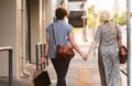 Young lesbian couple walking in the city carrying shopping bags Royalty Free Stock Photo