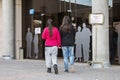 Young lesbian couple walking together towards electoral college at Spanish general election day in Madrid, Spain