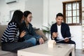 young lesbian married couple discussing agreement with skilled real estate agent or broker. Professional financial Royalty Free Stock Photo