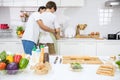 Young lgbtq Asian gay boyfriend hug partner in kitchen during cook Royalty Free Stock Photo