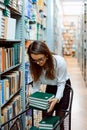 Young librarian worker with new books Royalty Free Stock Photo