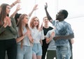 Young like-minded people giving each other a high five Royalty Free Stock Photo