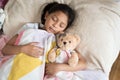 Young little asian girl sleeping while hugging teddy bear Royalty Free Stock Photo