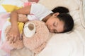 Young little asian girl sleeping while hugging teddy bear Royalty Free Stock Photo