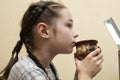 Young little baby girl drinking milk mug coffee tea hot drink. 9 years old girl drinks milk or tea from a cup Royalty Free Stock Photo