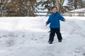 Young little boy enjoying sledding outside on a snow day Royalty Free Stock Photo