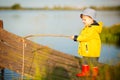 Young little boy fishing from wooden dock Royalty Free Stock Photo