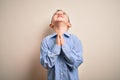 Young little boy kid wearing elegant shirt standing over isolated background begging and praying with hands together with hope Royalty Free Stock Photo