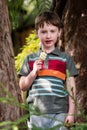 Young little boy portrait eating popsicle looking at camera Royalty Free Stock Photo