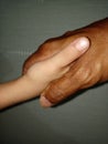 Young little boy shaking hands with old man Young and old combination clousup photo Royalty Free Stock Photo