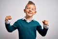 Young little caucasian kid with blue eyes standing wearing elegant clothes over isolated background very happy and excited doing Royalty Free Stock Photo