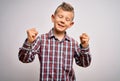 Young little caucasian kid with blue eyes wearing elegant shirt standing over isolated background very happy and excited doing Royalty Free Stock Photo
