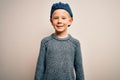 Young little caucasian kid with blue eyes wearing wool cap over isolated background with a happy and cool smile on face Royalty Free Stock Photo