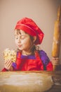 Young little chef girl preparing sweet desert at home kitchen. Nutrition and education concept. Vertical image Royalty Free Stock Photo