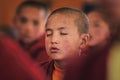 Young little child meditating / dreaming with closed eyes at the regular puja from Leh village. Ladakh