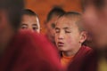 Young little child meditating / dreaming with closed eyes at the regular puja from Leh village. Ladakh