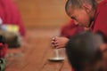 Young little child meditating / dreaming with open eyes at the regular puja from Leh village. Ladakh