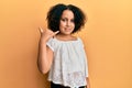 Young little girl with afro hair wearing casual clothes smiling doing phone gesture with hand and fingers like talking on the Royalty Free Stock Photo