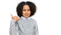 Young little girl with afro hair wearing casual clothes smiling doing phone gesture with hand and fingers like talking on the Royalty Free Stock Photo