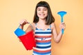 Young little girl with bang playing with summer shovel and bucket toys smiling with a happy and cool smile on face