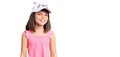 Young little girl with bang wearing funny kitty cap looking positive and happy standing and smiling with a confident smile showing Royalty Free Stock Photo