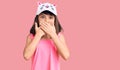 Young little girl with bang wearing funny kitty cap shocked covering mouth with hands for mistake Royalty Free Stock Photo