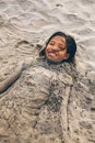 Young little girl playing on the beach covered with the sand Royalty Free Stock Photo