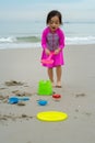 A young little girl playing sand at the beach - close up photo of the sand Royalty Free Stock Photo