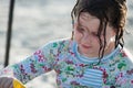 Young little girl playing with the sand and building sandcastle at the beach near the sea. Royalty Free Stock Photo