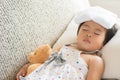 Young little girl sleeping and sick on the sofa with cooler gel Royalty Free Stock Photo