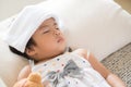 Young little girl sleeping and sick on the sofa with cooler gel Royalty Free Stock Photo