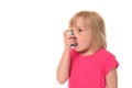 Young little girl using inhaler