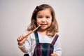 Young little infant girl brushing her teeth using tooth brush and oral paste, cleaning teeth and tongue as healthy health care Royalty Free Stock Photo