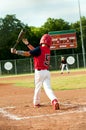Young little league boy swings bat Royalty Free Stock Photo