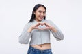 A young and lively asian woman making a heart shape with both hands. Isolated on a white background Royalty Free Stock Photo