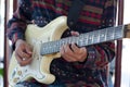 Young Living and practicing electric guitar happily at home.