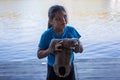 Young Brazilian girl holding a sloth along the Amazon River in Brazil, South America