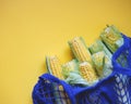 Young local corn in a blue eco friendly shopping bag Royalty Free Stock Photo