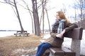 Young lonely woman on bench in park Royalty Free Stock Photo
