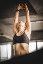 Young long blond woman attractive fitness exercise workout in gym. Woman stretching the muscles and relaxing after exercise Royalty Free Stock Photo