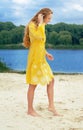 Young long-haired attractive woman in yellow outfi