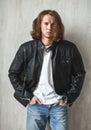 Young long-haired hunk with bristle in imposingly pose Royalty Free Stock Photo