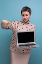 young looking business woman with gray streaked short hair demonstrates blank screen for promotional offer Royalty Free Stock Photo